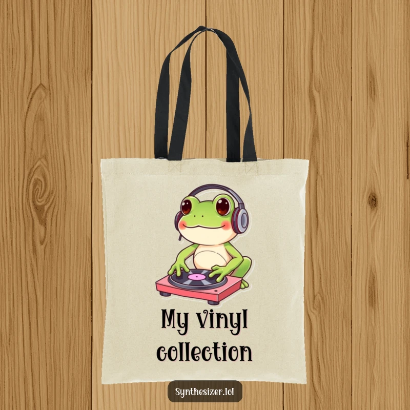 Funny frog DJ tote bag with headphones, tapping a turntable, ideal for carrying music essentials with humorous flair.